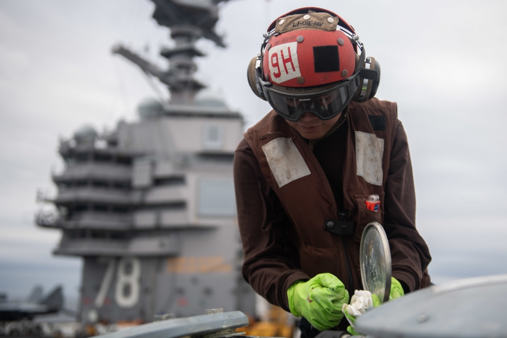 U.S. Sailor does maintenance on an MH-60S Sea Hawk