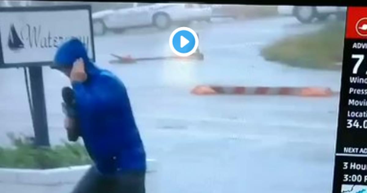 FAIL: Weatherman dramatically braces for winds as two men walk by