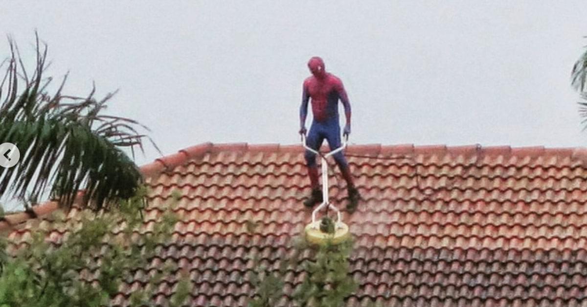 Man Dressed as Spiderman Seen Power Washing Roof