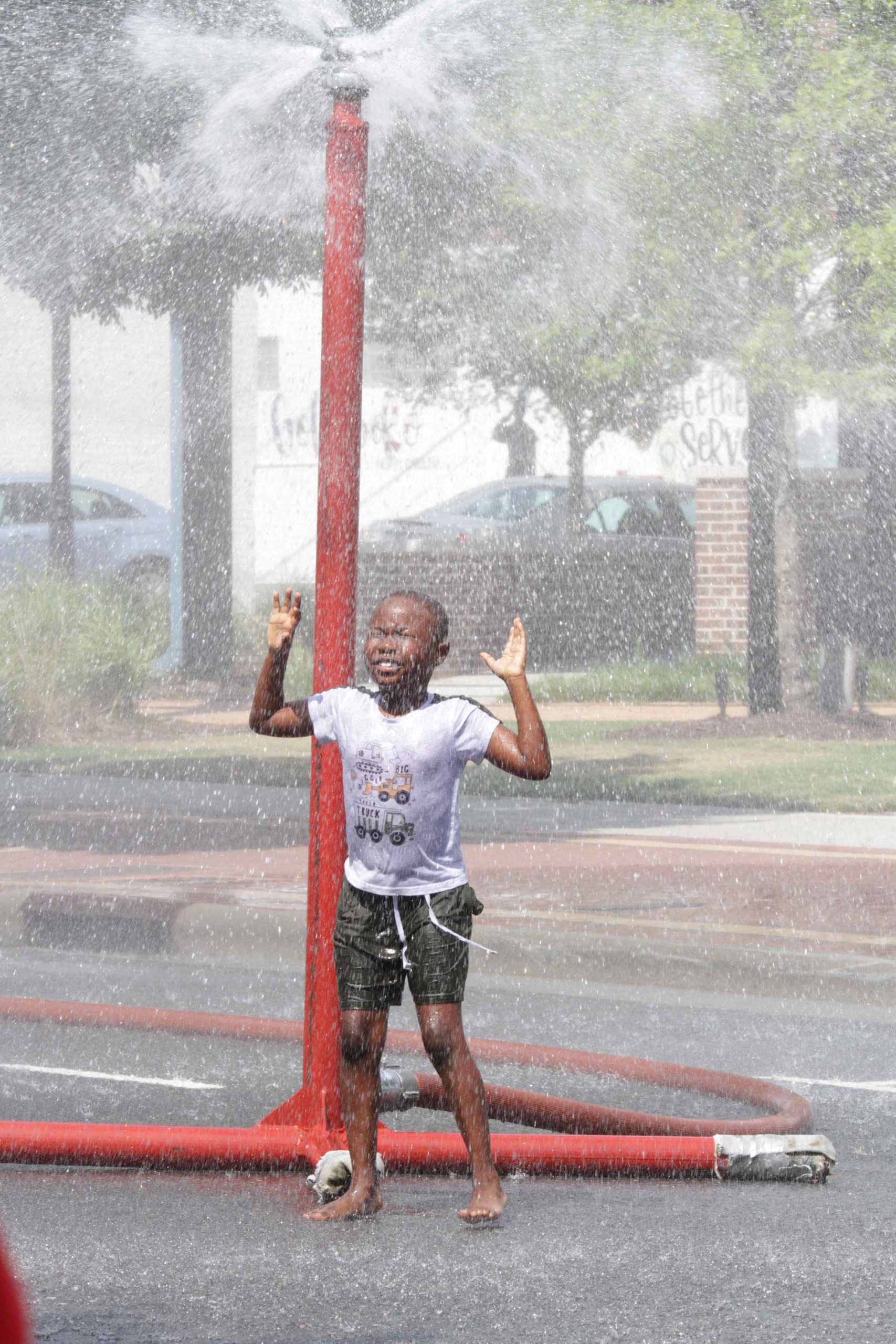 Kids Cool off During Sprinkler Days
