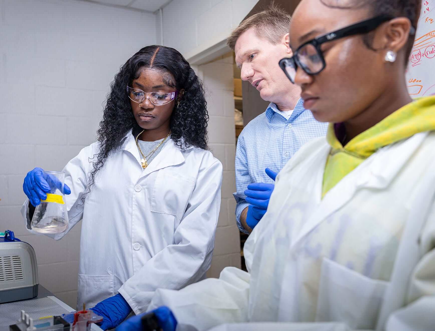 Robert Newman, Ph.D., Nathan F. Simms Distinguished Professor in the Department of Biology at North Carolina Agricultural and Technical State University, works with student researchers in his biology lab on campus.