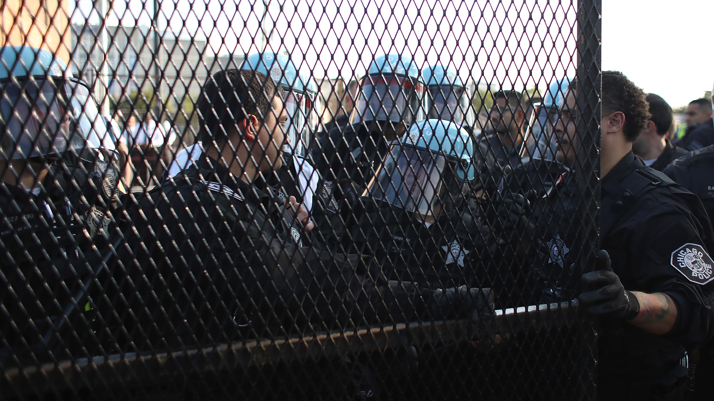 Some protesters tear down security fence as thousands march outside Democratic National Convention