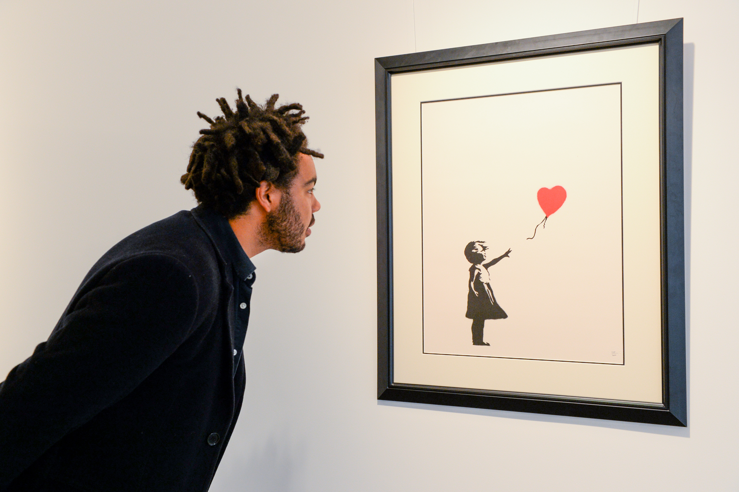 2 men are charged with stealing a famous Banksy artwork from a London gallery