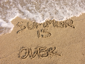 Summer is over - handwriting on the beach sand