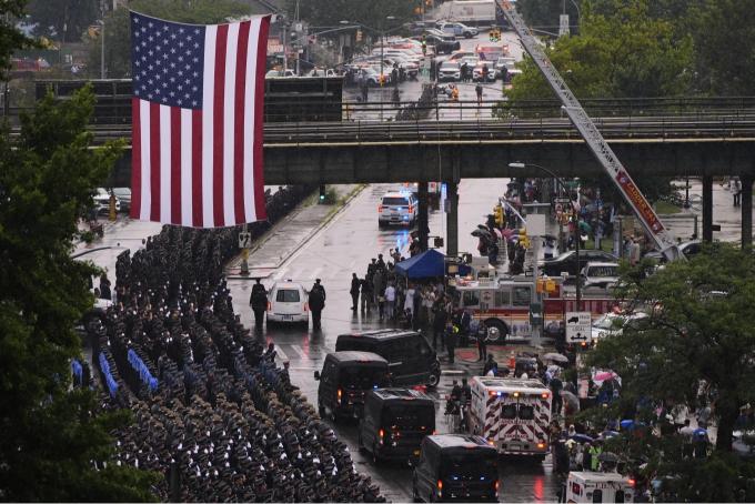 Mourners honor the NYPD officer killed in the attack at the NFL headquarters building