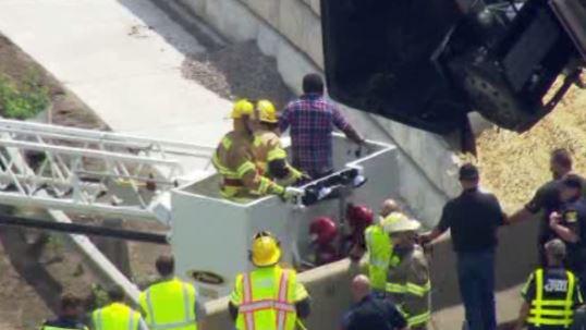 Crews rescue driver from dangling semi-truck on I-94