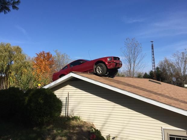 Car lands on roof of Michigan house