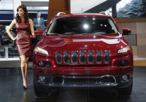 a-model-poses-next-to-a-jeep-cherokee-during-the-press-preview-day-of-the-north-american-international-auto-show-in-detroit-michigan-january-14-2014-reutersrebecca-cook