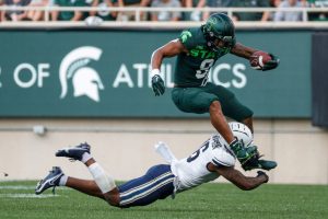 Michigan State running back Jalen Berger runs against Akron defensive back Nate Thompson during the first half at Spartan Stadium in East Lansing. Photo: Junfu Han / USA TODAY NETWORK