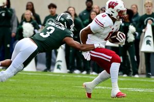 October 15, 2022 ~ Wisconsin Badgers running back Braelon Allen runs for a first down against Michigan State Spartans safety Xavier Henderson at Spartan Stadium. Photo: Dale Young-USA TODAY Sports