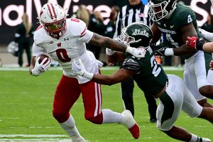 October 15, 2022 ~ Wisconsin Badgers running back Braelon Allen pushes away Michigan State Spartans defensive back Dillon Tatum in the first quarter for a first down at Spartan Stadium. Photo: Dale Young-USA TODAY Sports