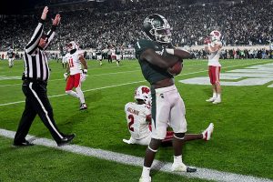 October 15, 2022 ~ Michigan State Spartans wide receiver Jayden Reed catches a touchdown pass in spite of Wisconsin Badgers cornerback Ricardo Hallman in a second overtime period to win the game, 34-28, at Spartan Stadium. Photo: Dale Young-USA TODAY Sports