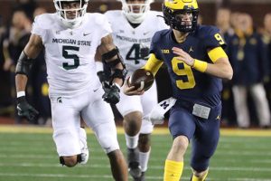 October 29, 2022 ~ Michigan quarterback J.J. McCarthy runs by Michigan State defensive end Michael Fletcher during the first half of the Michigan / Michigan State game in Ann Arbor. Photo: Kirthmon F. Dozier / USA TODAY NETWORK