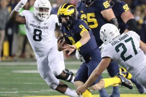 October 29, 2022 ~ Michigan quarterback J.J. McCarthy runs by Michigan State defenders during the first half of Michigan / Michigan State game in Ann Arbor. Photo: Kirthmon F. Dozier / USA TODAY NETWORK