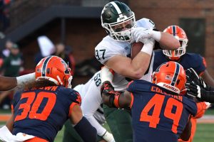 November 5, 2022 ~ Michigan State Spartans tight end Tyler Hunt is tackled by Illinois Fighting Illini defensive back Sydney Brown and teammate Seth Coleman during the second half at Memorial Stadium. Photo: Ron Johnson-USA TODAY Sports