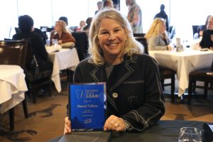 November 19, 2022 ~ BasBlue Co-Founder Nancy Tellem displays her award at the 2022 Women Who Lead Honoree Ceremony inside Joe Muer Seafood in Detroit’s Renaissance Center. Photo: Sean Boeberitz / WJR