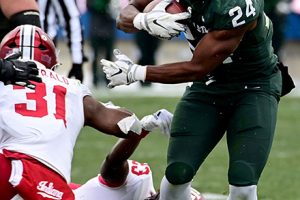 November 19, 2022 ~ Michigan State Spartans running back Elijah Collins runs through a hole in the Indiana Hoosiers line in the fourth quarter at Spartan Stadium. Photo: Dale Young-USA TODAY Sports