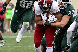 November 19, 2022 ~ Indiana Hoosiers running back Josh Henderson gets tackled by Michigan State Spartans linebacker Cal Haladay and defensive end Avery Dunn at Spartan Stadium. Photo: Dale Young-USA TODAY Sports