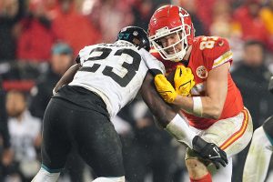 January 21, 2023 ~ Kansas City Chiefs tight end Travis Kelce runs the ball against Jacksonville Jaguars linebacker Foyesade Oluokun during the second half in the AFC divisional round game at Arrowhead Stadium. Photo: Jay Biggerstaff ~ USA TODAY Sports