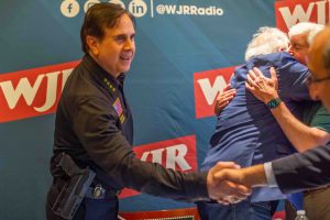 Oakland County Sheriff Michael Bouchard shakes hands at the launch of "Focus with Paul W. Smith" on June 20, 2023.