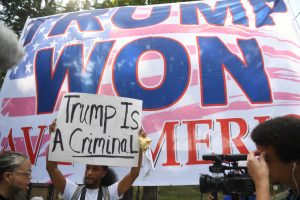 Aug. 24, 2023 ~ Protesters stand outside the at Fulton County Jail intake center in Atlanta, GA. on Aug 24, 2023, waiting for the arrival of former President Donald Trump. A grand jury in Fulton County, Georgia indicted former president Donald Trump and 18 other defendants with 41 charges related to tampering with the 2020 election. All defendants have been ordered to turn themselves in by August 25. Photo: Katie Goodale ~ USA TODAY NETWORK