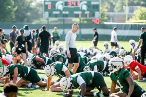 August 3, 2023 ~ Michigan State's offensive coordinator Jay Johnson, center, walks among the players during the opening day of MSU's football fall camp. Photo: Nick King ~ USA TODAY NETWORK