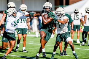 August 3, 2023 ~ Michigan State tight end Ademola Faleye, center, runs with the ball as defensive backs Armorion Smith, left, and Jaden Mangham close in during the opening day of MSU's football fall camp. Photo: Nick King ~ USA TODAY NETWORK
