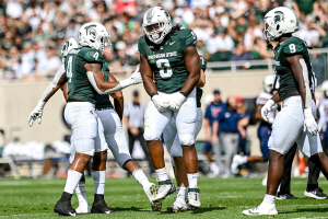 Sept. 9, 2023 ~ Michigan State's Simeon Barrow Jr., center, celebrates his sack against Richmond during the first quarter at Spartan Stadium in East Lansing. Photo: Nick King ~ USA TODAY NETWORK