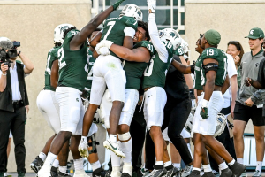 Sept. 9, 2023 ~ Michigan State's Antonio Gates Jr., center, is picked up by teammate Derrick Harmon and celebrated by teammates after Gates' touchdown catch against Richmond during the fourth quarter at Spartan Stadium in East Lansing. Photo: Nick King ~ USA TODAY NETWORK