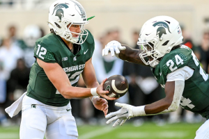 Sept. 9, 2023 ~ Michigan State's Katin Houser, left, hands the ball off to Davion Primm during the fourth quarter in the game against Richmond at Spartan Stadium in East Lansing. Photo: Nick King ~ USA TODAY NETWORK