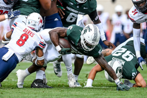 Sept. 9, 2023 ~ Michigan State's Nathan Carter dives for extra yards as Richmond's Aaron Banks defends during the first quarter at Spartan Stadium in East Lansing. Photo: Nick King ~ USA TODAY NETWORK
