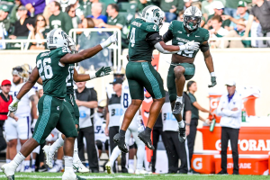 Sept. 16, 2023 ~ Michigan State's Armorion Smith, right, celebrates after nearly intercepting a Washington ball on third down during the first quarter at Spartan Stadium in East Lansing. Photo: Nick King ~ USA TODAY NETWORK