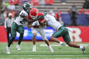 Oct. 14, 2023 ~ Rutgers Scarlet Knights wide receiver Christian Dremel (6) is tackled by Michigan State Spartans defensive back Chance Rucker (25) and defensive back Jaden Mangham (1) during the first half at SHI Stadium. Photo: Vincent Carchietta ~ USA TODAY Sports