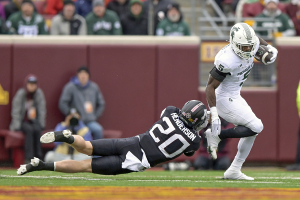 Oct. 28, 2023 ~ Michigan State Spartans running back Nate Carter (5) breaks the tackle of Minnesota Golden Gophers defensive back Jack Henderson (20) during the first quarter at Huntington Bank Stadium. Photo: Nick Wosika ~ USA TODAY