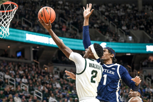 Nov. 17, 2023 ~ Michigan State's Tyson Walker, left, scores and is fouled by Butler's Jalen Thomas during the first half in East Lansing. Photo: Nick King ~ USA TODAY NETWORK