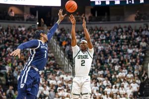 Nov. 17, 2023 ~ Michigan State's Tyson Walker, right, makes a 3-pointer as Butler's Jalen Thomas defends during the first half in East Lansing. Photo: Nick King ~ USA TODAY NETWORK