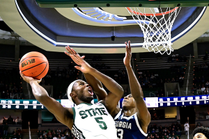 Nov. 28, 2023 ~ Michigan State Spartans guard Tre Holloman (5) scores on Georgia Southern Eagles guard Eren Banks (13) during the second half at Jack Breslin Student Events Center. Photo: Dale Young ~ USA TODAY Sports