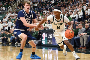 Nov. 28, 2023 ~ Michigan State Spartans guard Tyson Walker (2) drives past Georgia Southern Eagles forward Nate Brafford (23) during the second half at Jack Breslin Student Events Center. Photo: Dale Young ~ USA TODAY Sports