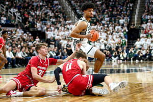 Dec. 5, 2023 ~ Michigan State's Malik Hall, right, gets past Wisconsin's Nolan Winter, left, and Max Klesmit during the first half at the Breslin Center in East Lansing. Photo: Nick King ~ USA TODAY NETWORK