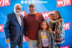 Paul W. Smith talks to veterans and military service members during the 2023 760 WJR Christmas On Us broadcast on Dec. 15 at the Guernsey Farms Dairy.