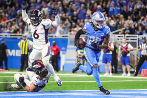 Dec. 16, 2023 ~ Detroit Lions running back Jahmyr Gibbs (26) runs into the end zone for a touchdown against Denver Broncos linebacker Alex Singleton (49) during the first half at Ford Field. Photo: Junfu Han ~ USA TODAY NETWORK