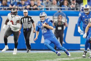 Jan. 21, 2024 ~ Detroit Lions quarterback Jared Goff (16) keeps the ball for a run against Tampa Bay Buccaneers during the first half of the NFC divisional round at Ford Field in Detroit on Sunday, Jan. 21. 2024.