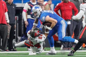 Jan. 21, 2024 ~ Detroit Lions tight end Sam LaPorta (87) runs against Tampa Bay Buccaneers cornerback Carlton Davis III (24) during the first half of the NFC divisional round at Ford Field in Detroit on Sunday, Jan. 21, 2024.