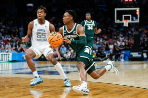 March 23, 2024 ~ Michigan State guard Tyson Walker dribbles against North Carolina forward Harrison Ingram during the second half of the NCAA Tournament West Region second round at Spectrum Center in Charlotte. Photo: Junfu Han ~ USA TODAY NETWORK