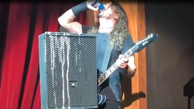 Watch Dave Grohl Chug A Beer And Fall Off Stage While Performing At CES