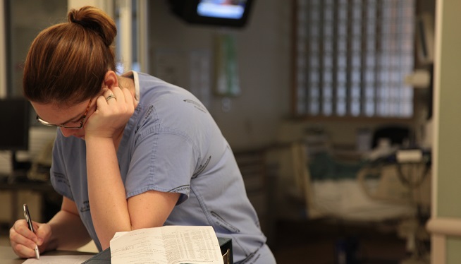 [FILE] A hospital worker leans against a desk to work inside the emergency department at Emory Hospital in Atlanta, Georgia.