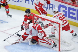 Oct. 3, 2023 ~ Chicago Blackhawks center Cole Guttman (70) tries to score against Detroit Red Wings goaltender Ville Husso (35) during the second period of a preseason hockey game at United Center. Photo: Kamil Krzaczynski ~ USA TODAY Sports