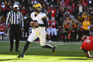 Nov. 18, 2023 ~ Michigan Wolverines quarterback J.J. McCarthy (9) rolls out against the Maryland Terrapins during the first half at SECU Stadium. Photo: Brad Mills ~ USA TODAY Sports