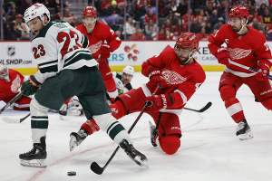 Nov. 26, 2023 ~ Detroit Red Wings defenseman Shayne Gostisbehere (41) and Minnesota Wild center Marco Rossi (23) battle for the puck in the third period at Little Caesars Arena. Photo: Rick Osentoski ~ USA TODAY Sports
