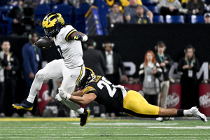 Dec. 2, 2023 ~ Michigan Wolverines running back Donovan Edwards (7) rushes up the field against Iowa Hawkeyes defensive back Sebastian Castro (29) during the game at Lucas Oil Stadium in Indianapolis. The Michigan Wolverines defeated the Iowa Hawkeyes, 26-0. Photo: Grace Hollars ~ USA TODAY NETWORK